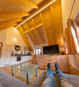 a person laying on the couch in a living room at Gästehaus Biohof Leutschach in Leutschach