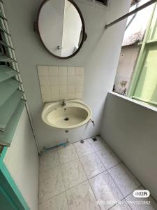 a bathroom with a sink and a mirror at 辉煌 Icon 民宿 in Bangkok