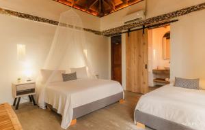 Postel nebo postele na pokoji v ubytování Rosario EcoHotel