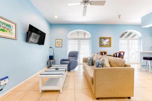 a living room with a couch and a tv at The Frontier Flat in Key West
