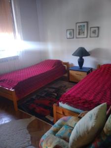 a bedroom with two beds and a lamp on a table at Sobe Centar in Visoko