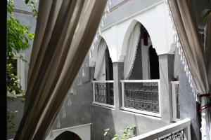 a window with a view of a building at Riad les 2 Portes in Marrakesh