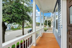 a porch of a white house with a white fence at Renovated Beach Bungalow! in Galveston