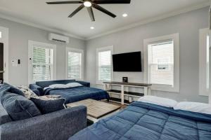 a living room with two beds and a flat screen tv at Renovated Beach Bungalow! in Galveston