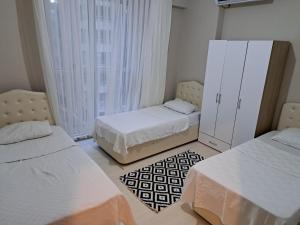 a bedroom with two beds and a window at AKUA 23 in Trabzon