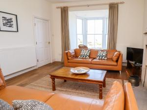 a living room with a couch and a coffee table at No6 Sea Lane in Embleton