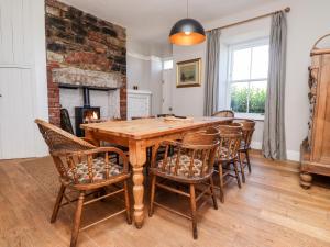 a dining room with a wooden table and chairs at No6 Sea Lane in Embleton