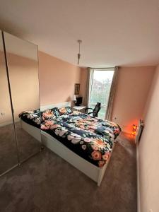a bedroom with a bed and a mirror and a desk at Repton house in Woodford