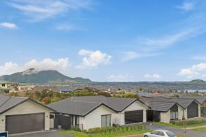 a row of houses with a mountain in the background at Sanctuary on the Grove in Taupo