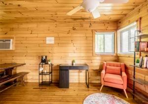 a room with a desk and a chair in a wooden room at Lazy Bear Cabin near Nantahala Outdoor Center and Bryson City in Bryson City