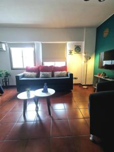 a living room with a couch and a table at DEPARTAMENTO a 5 cuadras de la Av Aristides - Ubicacion super privilegiada in Mendoza