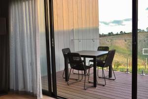 a table and chairs on a balcony with a view at Marnong Estate in Mickleham