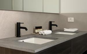 a bathroom counter with two sinks and two faucets at Marnong Estate in Mickleham