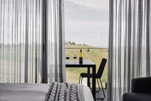 a bedroom with a table with two glasses of wine at Marnong Estate in Mickleham +8 photos