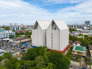 an overhead view of a white building in a city at Blue Hippo Hotel in Ban Khlong Samrong