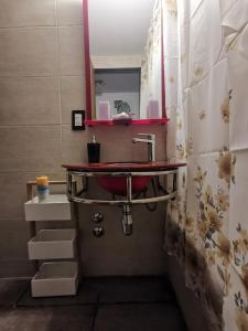 La salle de bains est pourvue d'un lavabo et d'un comptoir rouge. dans l'établissement DEPARTAMENTO a 5 cuadras de la Av Aristides - Ubicacion super privilegiada, à Mendoza