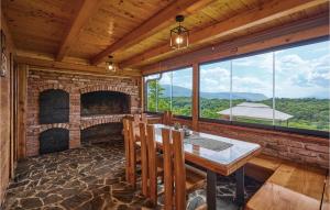 a dining room with a fireplace and a table and chairs at Nice Home In Kraljev Vrh With Sauna, Outdoor Swimming Pool And Heated Swimming Pool in Kraljev Vrh