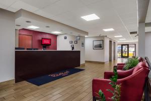 an office lobby with red chairs and a reception desk at Red Roof Inn Nashville - Music City in Nashville