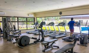 a man walking through a gym with cardio equipment at Arthomes BB3 in Mandaue City