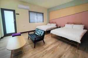 Ένα ή περισσότερα κρεβάτια σε δωμάτιο στο Sofa Potato Homestay