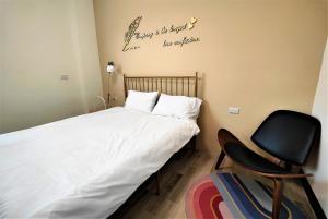 Ένα ή περισσότερα κρεβάτια σε δωμάτιο στο Sofa Potato Homestay