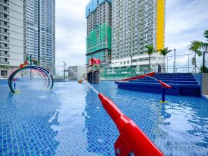a pool with a water slide in a city at Bali Residences Sea View Suites Melaka in Melaka