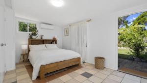 Postel nebo postele na pokoji v ubytování Magnolia Cottage