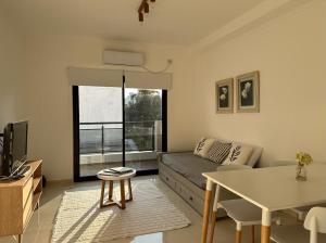 a living room with a couch and a table at Hermoso Depto in Corrientes
