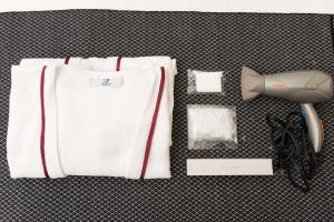 a white towel with a hair dryer and a hairdryer at La Cochinilla Hotel Boutique in Oaxaca City