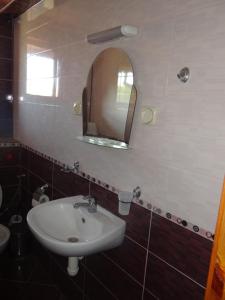 a bathroom with a sink and a mirror at Guest House Lazur in Obzor