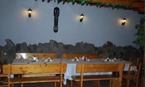 a table with four sinks in a room with rocks at Guest House Lazur in Obzor