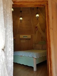 Cama pequeña en habitación con techo en Finland Village Pension en Geoje 