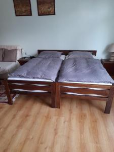 a bed in a room with a wooden floor at Apartment Mirjana in Banja Luka