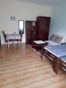 a living room with a bed and a table at Apartment Mirjana in Banja Luka