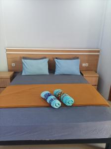 Ένα ή περισσότερα κρεβάτια σε δωμάτιο στο Merendeng Hostel Kuta