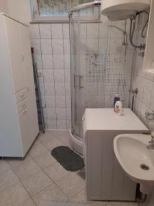 a bathroom with a shower and a sink and a toilet at Apartment Mirjana in Banja Luka