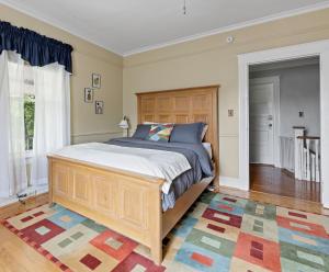a bedroom with a large bed and a rug at NEW! Modern Victorian Home in Danville