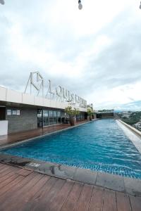 a swimming pool on the roof of a building at Warhol Residence at Louise Kienne Simpang Lima Semarang in Semarang