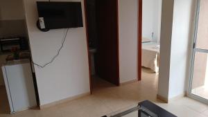 a living room with a television on a wall at B & V departamentos in San Salvador de Jujuy