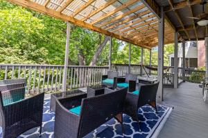 a patio with chairs and tables on a deck at NEW! Modern Victorian Home in Danville