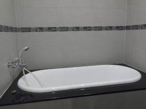 a white bath tub sitting on a counter in a bathroom at Mi Casa Homestay in Jiufen