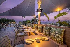 a restaurant with tables and chairs on a deck at Crowne Plaza Limassol by IHG in Limassol