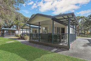 a house with a covered porch in a park at Reflections North Haven - Holiday Park in North Haven