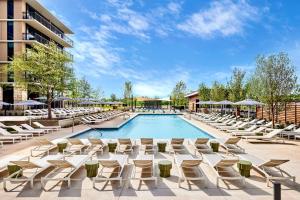 uma piscina com espreguiçadeiras e um hotel em Omni PGA Resort Frisco-Dallas em Frisco