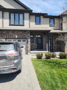 a car parked in front of a house at Prestige Guest Room London Ontario in London