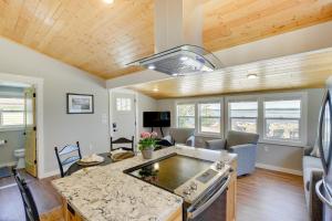 a kitchen and living room with a couch and a stove at Baileys Harbor Waterfront Vacation Rental with Grill in Baileys Harbor