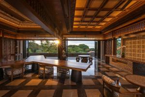 a dining room with a table and a large window at AYANA Segara Bali in Jimbaran