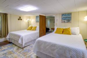 a bedroom with two beds with white sheets and yellow pillows at Jefferson City Getaway - 3 Mi to Cherokee Lake! in Jefferson City
