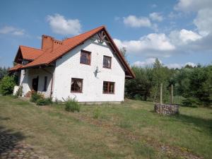 ein weißes Haus mit rotem Dach in der Unterkunft Chatka skrzatka 