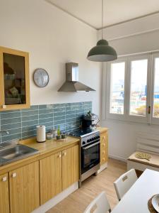 a kitchen with a sink and a stove top oven at Chez Lina - Appartamento Marina in Trapani